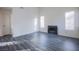 Bright living room featuring gray wood floors, neutral walls, fireplace, and natural light at 2696 Jennydiane Dr, Las Vegas, NV 89121