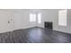 Bright living room with light gray wood floors, white walls, and a cozy fireplace at 2696 Jennydiane Dr, Las Vegas, NV 89121