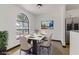 Dining area with natural light from large window, table with seating, and modern decor at 2963 Juniper Hills Blvd # 104, Las Vegas, NV 89142