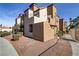 Multi-level condo featuring stucco exterior, tiled roof, and well-maintained landscaping at 2963 Juniper Hills Blvd # 104, Las Vegas, NV 89142
