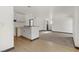 Unfurnished living room featuring view of kitchen, front door, and neutral flooring at 2963 Juniper Hills Blvd # 104, Las Vegas, NV 89142