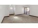 Unfurnished living room featuring sliding glass doors to patio and unique circular window feature at 2963 Juniper Hills Blvd # 104, Las Vegas, NV 89142