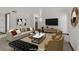 Comfortable living room featuring plush seating, modern art, and a contemporary entertainment center at 2963 Juniper Hills Blvd # 104, Las Vegas, NV 89142