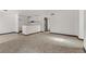 Unfurnished living room with open floor plan, neutral carpet and vinyl flooring, and modern finishes at 2963 Juniper Hills Blvd # 104, Las Vegas, NV 89142