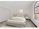 Staged bedroom features a comfy bed, accent wall art, and large window at 2963 Juniper Hills Blvd # 104, Las Vegas, NV 89142