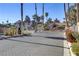 Gated community entrance with palm trees, desert landscaping, and secure access at 2963 Juniper Hills Blvd # 104, Las Vegas, NV 89142