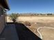 Expansive backyard featuring desert landscaping, mature bushes, and a clear view of the distant mountains at 3090 N Woodchips Rd, Pahrump, NV 89060