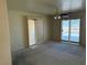 Bright bedroom features a ceiling fan, carpet and sliding glass door leading to an outdoor space at 3090 N Woodchips Rd, Pahrump, NV 89060