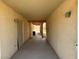 Covered outdoor walkway featuring stucco walls, overhead lighting, and wood trim at 3090 N Woodchips Rd, Pahrump, NV 89060