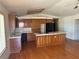 Spacious kitchen with dark wood cabinets, tiled counters, and a center island at 3090 N Woodchips Rd, Pahrump, NV 89060
