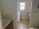 Bright laundry room with washer, dryer, utility sink, and built-in shelving at 3090 N Woodchips Rd, Pahrump, NV 89060