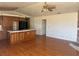 Open living space with wood floors, stone fireplace, and a view to the kitchen at 3090 N Woodchips Rd, Pahrump, NV 89060