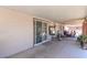 Large covered patio area with concrete flooring and sliding glass door at 3212 Osage Ave, Las Vegas, NV 89101
