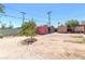 Large backyard with colorful storage sheds and mature trees at 3212 Osage Ave, Las Vegas, NV 89101