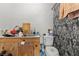 A bathroom is equipped with a toilet, a wooden sink, and a shower at 3212 Osage Ave, Las Vegas, NV 89101