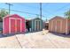 Three colorful storage sheds with a stone pathway in the backyard at 3212 Osage Ave, Las Vegas, NV 89101