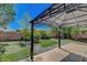 Inviting backyard space with a gazebo, putting green, mature landscaping, and brick patio at 3310 Hillside Garden Dr, Las Vegas, NV 89135