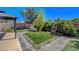 Lush backyard featuring a brick patio, small yard, privacy fence, fountain and mature trees at 3310 Hillside Garden Dr, Las Vegas, NV 89135