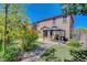 Backyard showcases a gazebo, putting green, brick patio, mature trees and tan stucco home at 3310 Hillside Garden Dr, Las Vegas, NV 89135