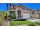 Beautiful two-story home featuring a well-maintained lawn and desert landscaping at 3310 Hillside Garden Dr, Las Vegas, NV 89135