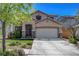 Charming two-story home with well-manicured landscaping and decorative stone accents at 3310 Hillside Garden Dr, Las Vegas, NV 89135