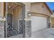 Close-up of the front entrance, showcasing a decorative security gate and stone accents at 3310 Hillside Garden Dr, Las Vegas, NV 89135