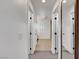 Well-lit hallway featuring neutral colored floors and white doors at 3310 Hillside Garden Dr, Las Vegas, NV 89135