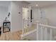 Second floor hallway featuring white banisters and wood flooring at 3310 Hillside Garden Dr, Las Vegas, NV 89135