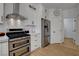 Bright kitchen with stainless steel appliances, including a double oven and a modern range hood at 3310 Hillside Garden Dr, Las Vegas, NV 89135