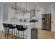 Bright kitchen with a large island, stainless steel appliances, and modern pendant lighting at 3310 Hillside Garden Dr, Las Vegas, NV 89135