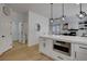 Open floor plan with a kitchen featuring white cabinets, stainless steel appliances, and a large island at 3310 Hillside Garden Dr, Las Vegas, NV 89135