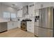 The kitchen features stainless steel appliances, white cabinets, and a herringbone tile backsplash at 3310 Hillside Garden Dr, Las Vegas, NV 89135