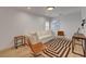 Neutral living room with contemporary furniture and a geometric rug at 3310 Hillside Garden Dr, Las Vegas, NV 89135