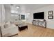 Bright living room with hardwood floors, modern furniture, and plenty of natural light at 3310 Hillside Garden Dr, Las Vegas, NV 89135