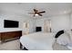Large main bedroom with neutral carpeting, a ceiling fan, and access to other rooms at 3310 Hillside Garden Dr, Las Vegas, NV 89135