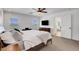 Spacious main bedroom with neutral carpeting, a ceiling fan, and access to the main bathroom at 3310 Hillside Garden Dr, Las Vegas, NV 89135