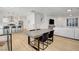 Open-concept dining area and kitchen featuring hardwood floors and modern finishes at 3310 Hillside Garden Dr, Las Vegas, NV 89135