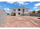 Backyard view showcasing a two-story home with a balcony, a rock garden, and a brick patio at 3632 Julia Waldene Ct, Las Vegas, NV 89129