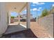 Backyard featuring a covered patio, rock landscaping, and a block wall surrounding the property at 3632 Julia Waldene Ct, Las Vegas, NV 89129