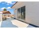 Cozy balcony featuring white stucco walls and sliding glass doors with views of the neighborhood at 3632 Julia Waldene Ct, Las Vegas, NV 89129