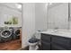 This full bathroom has a laundry area, vanity, and toilet at 3632 Julia Waldene Ct, Las Vegas, NV 89129