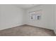 Bright, carpeted bedroom with a window offering natural light and views of the home exterior at 3632 Julia Waldene Ct, Las Vegas, NV 89129