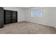 Spacious bedroom with neutral carpet, large window, and built-in bookcase at 3632 Julia Waldene Ct, Las Vegas, NV 89129