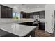 Modern kitchen features dark cabinetry, stainless steel appliances, and granite countertops at 3632 Julia Waldene Ct, Las Vegas, NV 89129