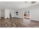 Bright living room featuring wood-look floors, white walls, and sliding glass doors for natural light at 3632 Julia Waldene Ct, Las Vegas, NV 89129