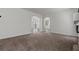 Spacious living room featuring carpet flooring, neutral paint, and ample natural light at 3632 Julia Waldene Ct, Las Vegas, NV 89129
