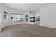 Spacious living room with carpet flooring, a fireplace, and bright windows at 3632 Julia Waldene Ct, Las Vegas, NV 89129