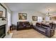 Large living room with vaulted ceilings, cozy sofas, and an adjoining dining space at 368 Umbria Way, Henderson, NV 89014