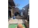 Unkept backyard with overgrown foliage and cluttered patio area with storage at 4238 Rollingstone Dr, Las Vegas, NV 89103
