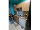 Compact kitchen area with essential appliances and cabinet storage at 4238 Rollingstone Dr, Las Vegas, NV 89103